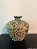 front view of clay vase urn showing bamboo design