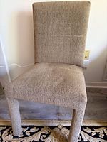 Front view of one upholstered dining chair