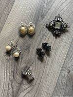 Group shot of all jewellery items on wood surface