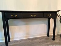 Full front view of black hall table