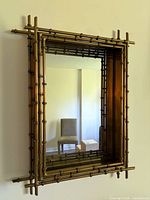 Front view of rectangular brass faux bamboo mirror on wall