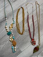 All four necklaces laid out for overview