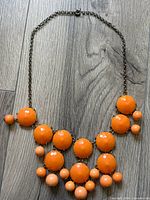 Full view of necklace laid flat showing bead design and chain