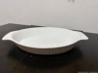 White oval fluted ceramic baking dish with handles