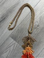 Multistrand metallic tassel necklace