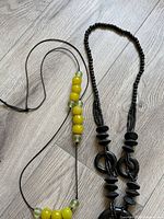 Both necklaces side by side on floor