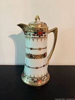 Ornate porcelain pitcher front view
