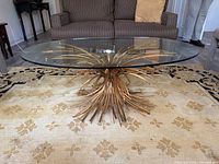 Full view of glass-top table showing wheat sheaf base
