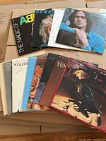 Top view of stacked LP jackets showing The Magic of ABBA, Bonnie Raitt, James Taylor JT, Streisand Songbird, Yentl and others