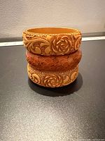 Three bangles stacked showing carving and snakeskin texture