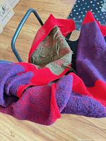 Scarf draped over chair showing red, purple and olive panels
