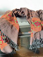 Full shawl draped showing woven pattern and fringe