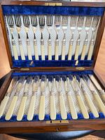 Open presentation box showing full set of 12 knives and 12 forks