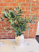 Full view of arrangement showing vase and foliage