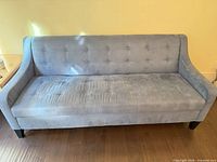 Front view of light blue tufted microfiber sofa