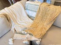 All three throw blankets displayed on couch