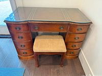 Front view of desk showing stool and all drawers