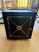 Front view closed showing silver trim X and medallion