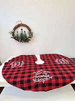 Tree skirt laid out flat with wreath above