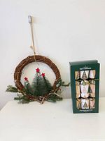 Wreath hanging next to boxed party crackers