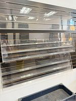 Front view of clear acrylic slatwall card racks on wall