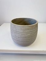 Angled view of gray concrete planter exterior