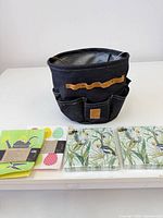 Lot overview showing gardening bag, three napkin packs, dishcloth