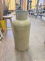 Full view of tall beige ceramic floor vase