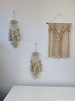 All three macrame wall hangings displayed on wall