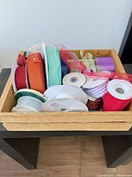 Entire lot of ribbon spools inside wood crate