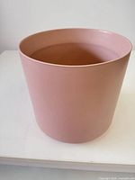 Front view of rose pink ceramic planter showing cylindrical shape and matte finish