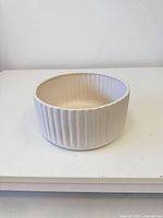 Planter angled view showing ribbed exterior and interior
