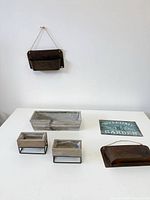 Overall lot showing hanging metal planter, three wooden planters, second metal planter, and garden sign