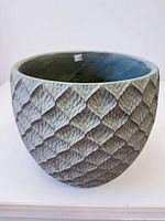 angled view of entire concrete planter showing exterior texture and color