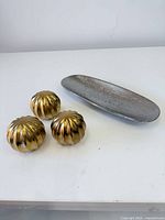 Three gold-tone metal spheres and hammered silver-tone tray overview