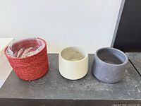 All three planters side by side showing colors, materials, sizes