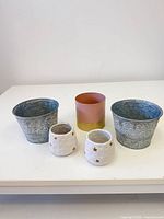 Front view of all five planters showing sizes, materials and patterns