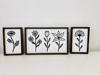 Front view of all three framed floral panels