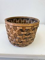 Overall view of woven wood plant basket exterior