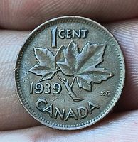 Reverse view showing maple leaves, date, denomination