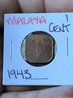 Reverse of 1943 Malaya 1 cent coin in holder