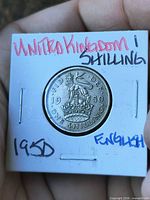 Reverse side of coin with crowned English shield and lion, denomination and year