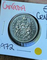 Reverse of 1972 Canada 50-cent coin in flip showing coat of arms