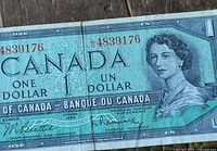 Front of 1954 Canadian $1 note showing Queen Elizabeth II portrait and red serial number 4839176