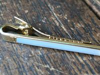 Side view showing gold-tone finish, mother-of-pearl strip and hinge mechanism