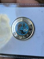 Obverse side showing blue colorized Arctic wildlife design and inscription