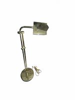 Full view of brass floor lamp showing adjustable arm and rectangular shade