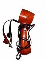 Side view of orange handset with wrapped leads and alligator clips