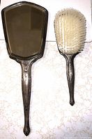 Front view of mirror and brush showing size and design