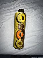 Full view of ceramic table lighter showing glaze colors and concentric circle design